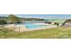 Community Pool featuring a large fenced swimming area and a scenic lake view, creating a perfect oasis at 623 Roxboro Dr, Mount Gilead, NC 27306