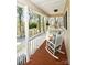 Inviting front porch with rocking chairs and hanging plants creating a relaxing space at 623 Roxboro Dr, Mount Gilead, NC 27306