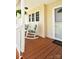 Charming front porch with inviting rocking chairs and tasteful décor, enhanced by hanging plants at 623 Roxboro Dr, Mount Gilead, NC 27306