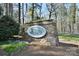 Stone monument sign for the Woodrun subdivision surrounded by lush landscaping at 623 Roxboro Dr, Mount Gilead, NC 27306