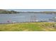 Stunning waterfront property with a private boat dock, lush green lawn, and a picturesque view of the lake at 623 Roxboro Dr, Mount Gilead, NC 27306