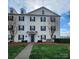 Inviting exterior of building with lush lawn, landscaping, and classic architectural details at 6423 Town Hall Pl, Harrisburg, NC 28075