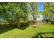 Beautiful backyard features green grass, mature trees, and a charming swing set at 6519 Summertree Ln, Charlotte, NC 28270