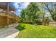 Spacious backyard featuring a well-maintained lawn, a wooden fence, and an outdoor swing set at 6519 Summertree Ln, Charlotte, NC 28270