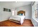 Bedroom featuring hardwood floors and light-filled interior at 6519 Summertree Ln, Charlotte, NC 28270