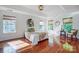 Bright bedroom featuring gleaming hardwood floors, neutral walls, large windows, and tray ceiling at 6519 Summertree Ln, Charlotte, NC 28270