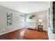Neutrally decorated bedroom featuring hardwood floors, a window, and a white iron frame bed at 6519 Summertree Ln, Charlotte, NC 28270