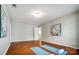 Bright bonus room featuring hardwood floors, recessed lighting, and convenient access to attic space at 6519 Summertree Ln, Charlotte, NC 28270