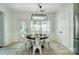 Dining area with bright light coming in from the windows and adjacent door at 6519 Summertree Ln, Charlotte, NC 28270