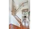 Inviting foyer featuring hardwood floors, stairway with wood banister and view into the living room at 6519 Summertree Ln, Charlotte, NC 28270
