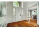 Bright foyer with hardwood floors, wainscoting, and arched transom window above the front door at 6519 Summertree Ln, Charlotte, NC 28270