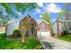 Beautiful two-story brick home with well-maintained lawn, attached garage, and mature trees at 6519 Summertree Ln, Charlotte, NC 28270