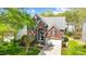 Two-story brick home with a manicured lawn, attached garage, and mature trees under a blue sky at 6519 Summertree Ln, Charlotte, NC 28270