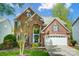 Charming two-story brick home featuring an attached two-car garage and manicured front lawn at 6519 Summertree Ln, Charlotte, NC 28270