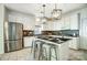 Modern kitchen featuring stainless steel appliances, island with bar stools, and sleek design at 6519 Summertree Ln, Charlotte, NC 28270