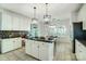 Modern kitchen featuring a central island with seating and adjacent dining area at 6519 Summertree Ln, Charlotte, NC 28270