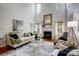 Bright living room featuring high ceilings, fireplace, and large windows for natural light at 6519 Summertree Ln, Charlotte, NC 28270