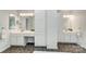 Elegant primary bathroom boasts double sinks, a vanity, tiled floors, and abundant storage at 6519 Summertree Ln, Charlotte, NC 28270