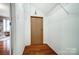 Spacious walk-in closet, with hardwood floors and wire shelving for optimal organization at 6519 Summertree Ln, Charlotte, NC 28270