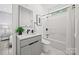 Modern bathroom boasting a tub with shower, vanity, sleek finishes, and a window for natural light at 6548 Emerald Isle Dr, Sherrills Ford, NC 28673