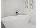 Beautiful bathroom features modern, free-standing bathtub with sleek black hardware and light tile backdrop at 6548 Emerald Isle Dr, Sherrills Ford, NC 28673