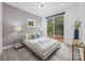 Cozy bedroom featuring deck access, a modern bed frame, bedside tables and large windows at 6548 Emerald Isle Dr, Sherrills Ford, NC 28673
