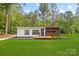 Modern home with a well-maintained lawn, minimalist landscaping, and inviting curb appeal at 6548 Emerald Isle Dr, Sherrills Ford, NC 28673