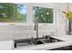 Close up of a modern kitchen sink with a view of the outdoors from a window above at 6548 Emerald Isle Dr, Sherrills Ford, NC 28673