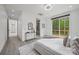 Bright main bedroom boasts light floors, access to a deck, and an en suite bathroom with glass enclosed shower at 6548 Emerald Isle Dr, Sherrills Ford, NC 28673