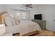 Bright bedroom featuring a ceiling fan, a television, and white walls at 6807 Stoney Ridge Rd, Matthews, NC 28104