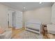 Bedroom with a crib, a changing table, and armchairs on a floral rug at 6807 Stoney Ridge Rd, Matthews, NC 28104