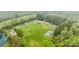 An aerial view of a community park with sports courts, a playground, and a lake, perfect for outdoor activities at 6807 Stoney Ridge Rd, Matthews, NC 28104