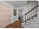 Welcoming entryway with hardwood floors, a staircase, and a glimpse into a bright office space at 6807 Stoney Ridge Rd, Matthews, NC 28104