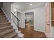 Inviting foyer with hardwood floors, staircase, and a view into the comfortably furnished living room at 6807 Stoney Ridge Rd, Matthews, NC 28104