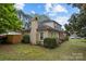 Charming home featuring a brick chimney, manicured landscaping, and a covered front porch adorned with an American flag at 6807 Stoney Ridge Rd, Matthews, NC 28104