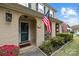 Inviting front entrance with charming brickwork, an American flag, and a welcoming Hello door mat at 6807 Stoney Ridge Rd, Matthews, NC 28104