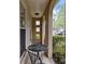 Cozy front porch features a metal table and chairs, perfect for enjoying the outdoors at 6807 Stoney Ridge Rd, Matthews, NC 28104