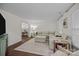 Bright living room with comfortable sectional sofa, hardwood floors, and an open doorway to the dining area at 6807 Stoney Ridge Rd, Matthews, NC 28104