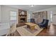 Relaxing living room features a brick fireplace, hardwood floors, and built-in storage at 6807 Stoney Ridge Rd, Matthews, NC 28104