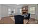 Inviting living room featuring a brick fireplace, hardwood floors, and neutral decor creating a warm atmosphere at 6807 Stoney Ridge Rd, Matthews, NC 28104