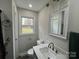 Bathroom featuring a large mirror above the vanity and a bright window at 8124 Wood St, Mount Pleasant, NC 28124