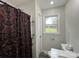 Bathroom featuring a window and decorative shower curtain at 8124 Wood St, Mount Pleasant, NC 28124