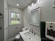 Bathroom featuring a large mirror above the vanity and a bright window at 8124 Wood St, Mount Pleasant, NC 28124