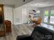 Open dining area with grey flooring, access to backyard, and adjacent shelving at 8124 Wood St, Mount Pleasant, NC 28124