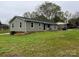 View of the home's exterior, featuring vinyl siding and a well-maintained lawn at 8124 Wood St, Mount Pleasant, NC 28124