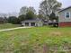 Exterior view of the detached garage, house, and deck at 8124 Wood St, Mount Pleasant, NC 28124