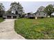 Exterior view of the home with detached garage and well-maintained lawn at 8124 Wood St, Mount Pleasant, NC 28124