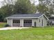 View of the two car garage with dark brown doors and siding at 8124 Wood St, Mount Pleasant, NC 28124