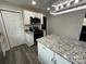 Modern kitchen featuring white cabinets, granite countertops, and stainless steel appliances at 8124 Wood St, Mount Pleasant, NC 28124