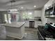 Bright kitchen featuring granite countertops, stainless steel appliances, and a view from the window at 8124 Wood St, Mount Pleasant, NC 28124